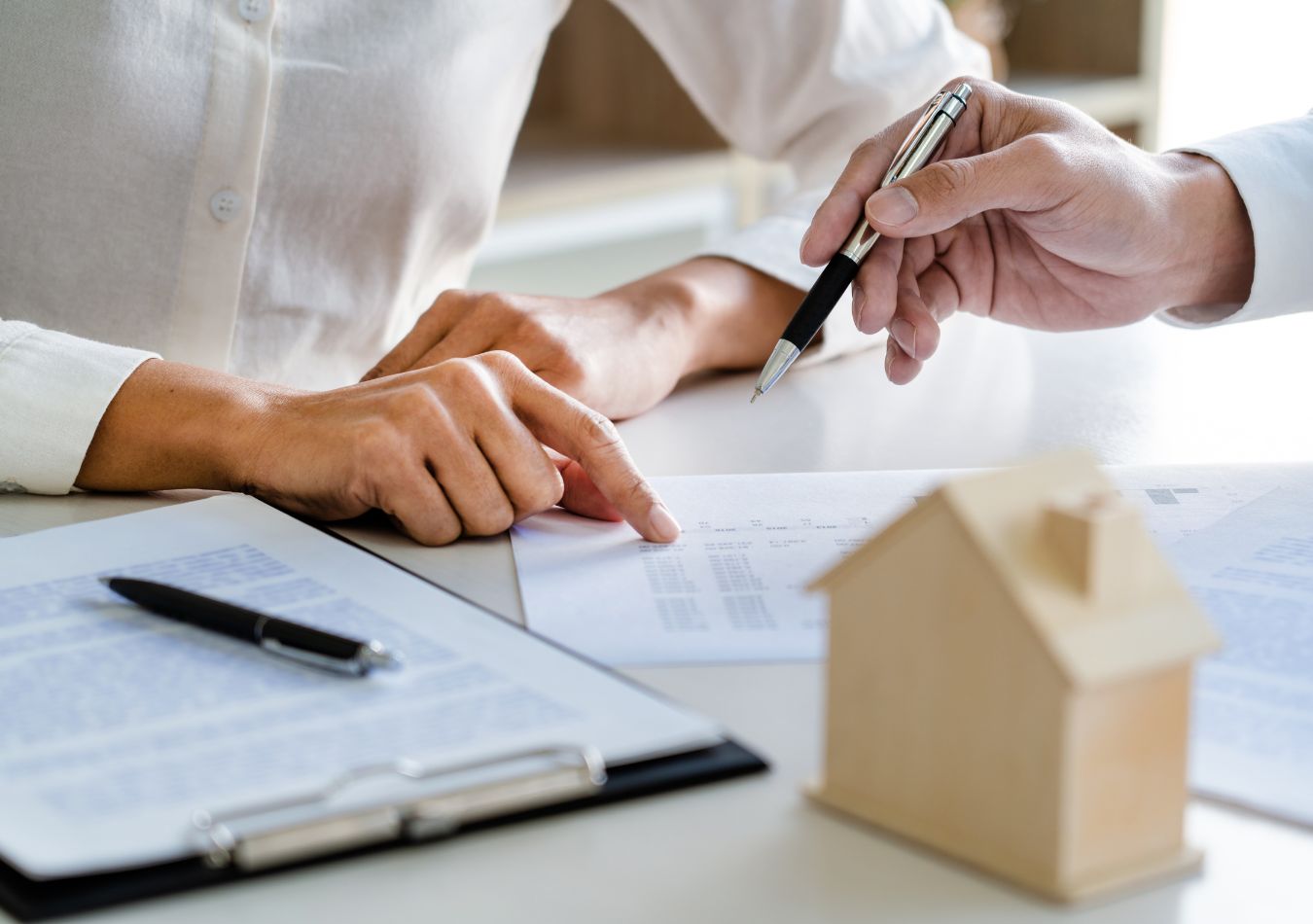 Real estate agent and client reviewing moving details together at a desk